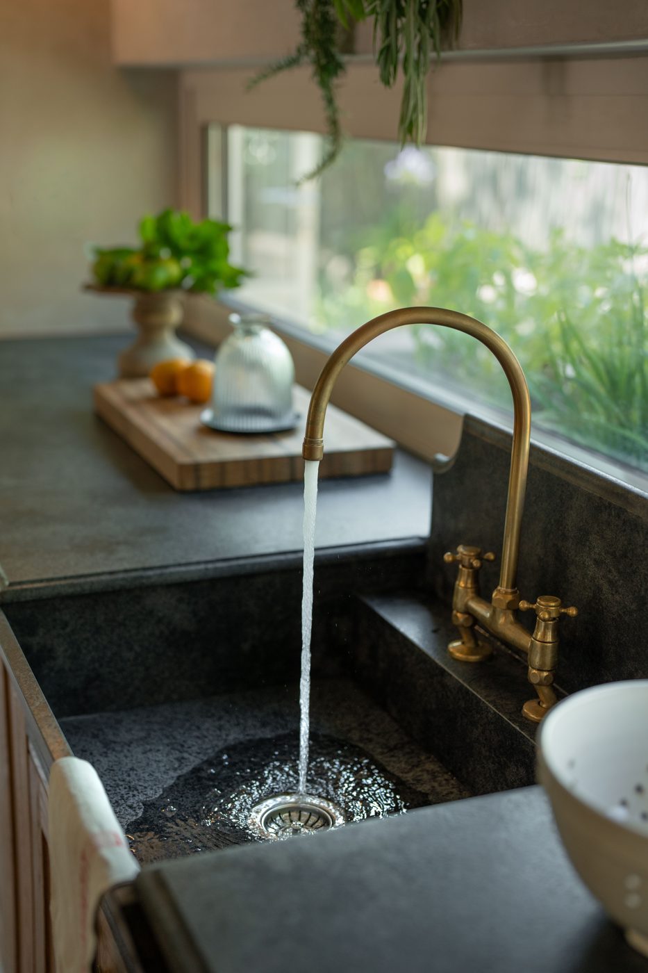 Scullery with brass tap and stone countertop in a Franschhoek home